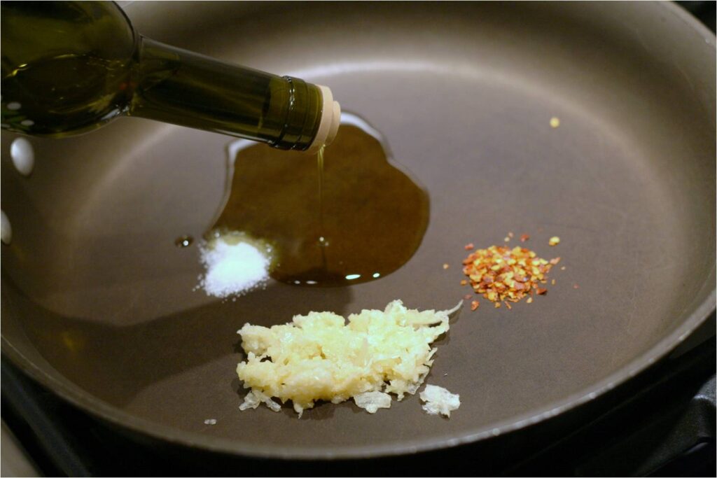 Add EVOO Pepper Flakes Garlic and Salt to Skillet