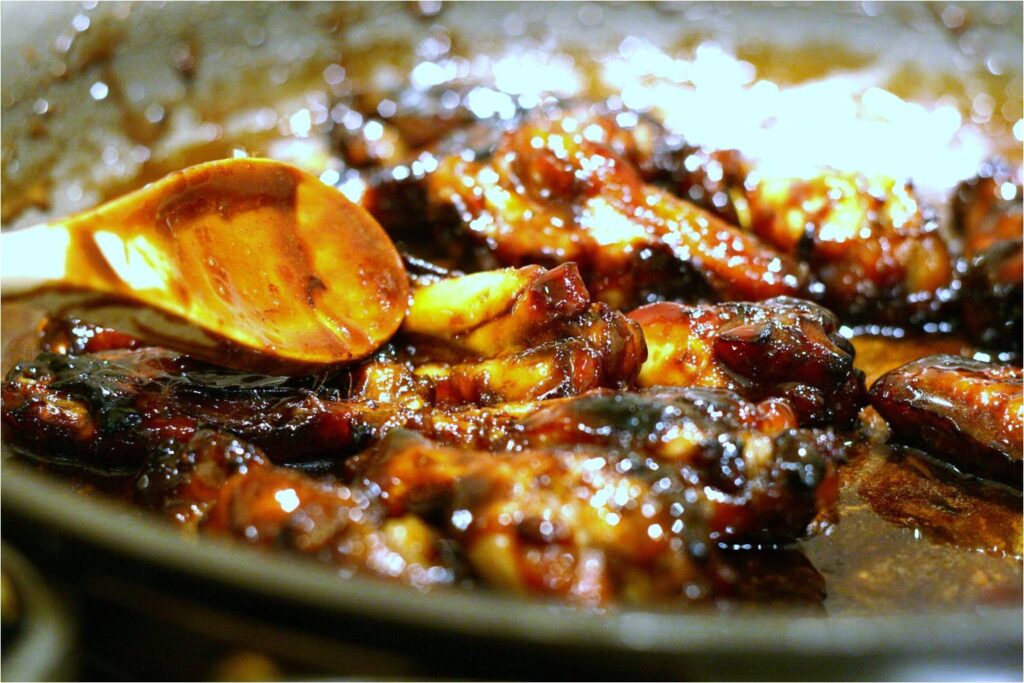 Add chicken wings to balsamic rosemary glaze in skillet