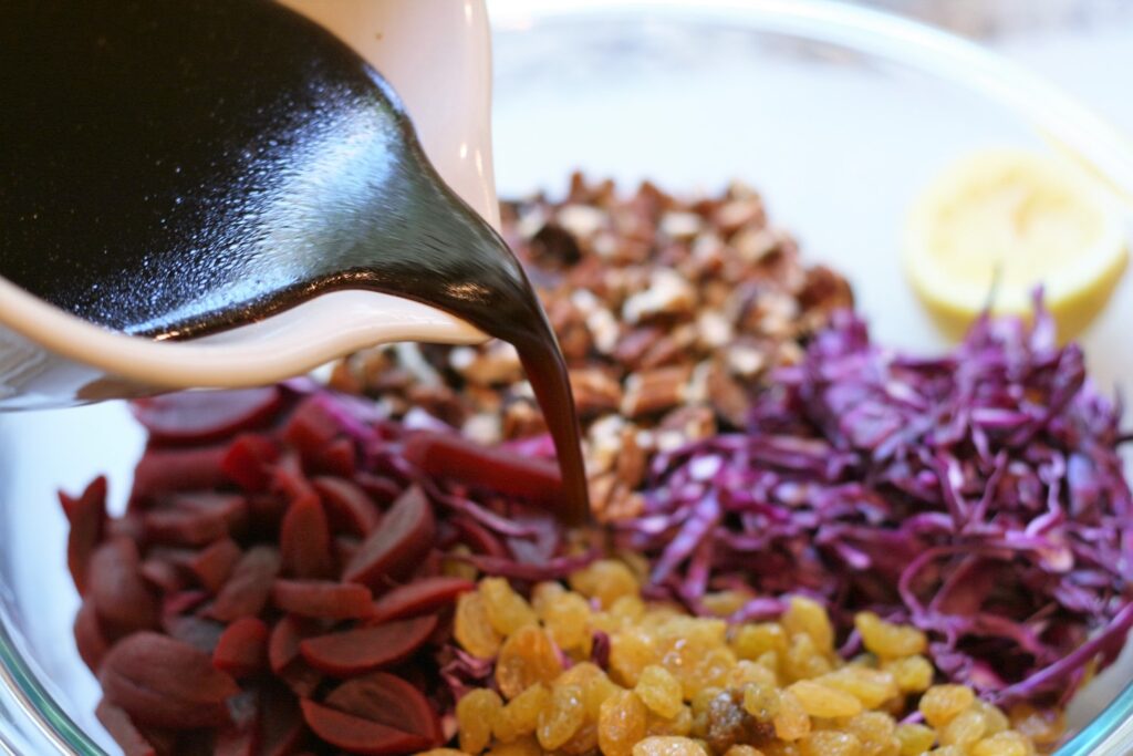 Add dressing to cabbage beet slaw