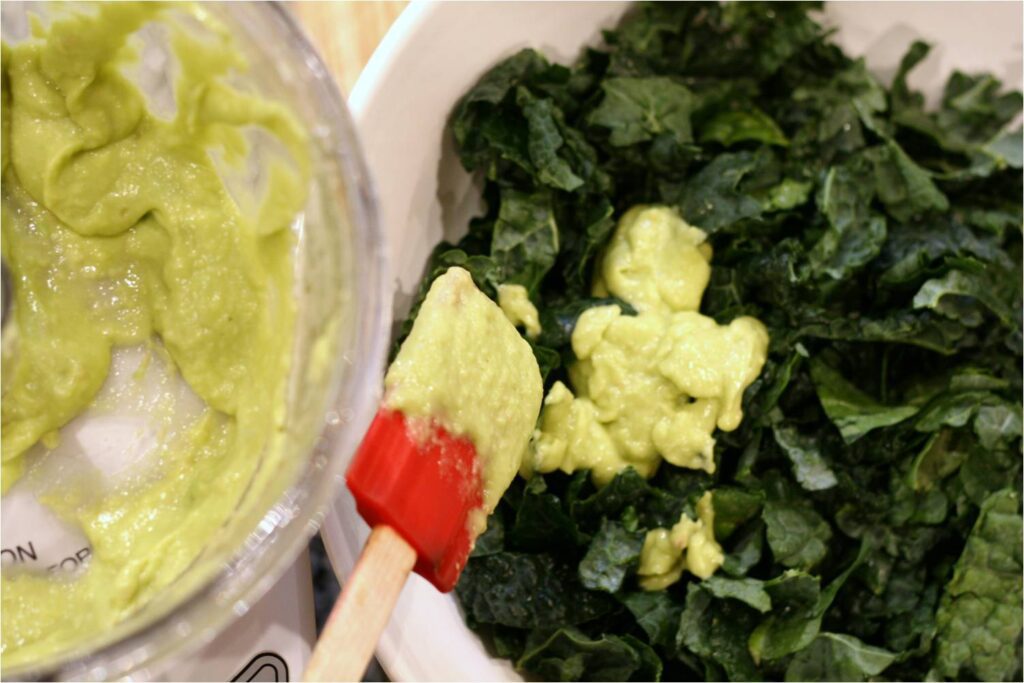 Add dressing to kale for Kale and Lentil Bowl