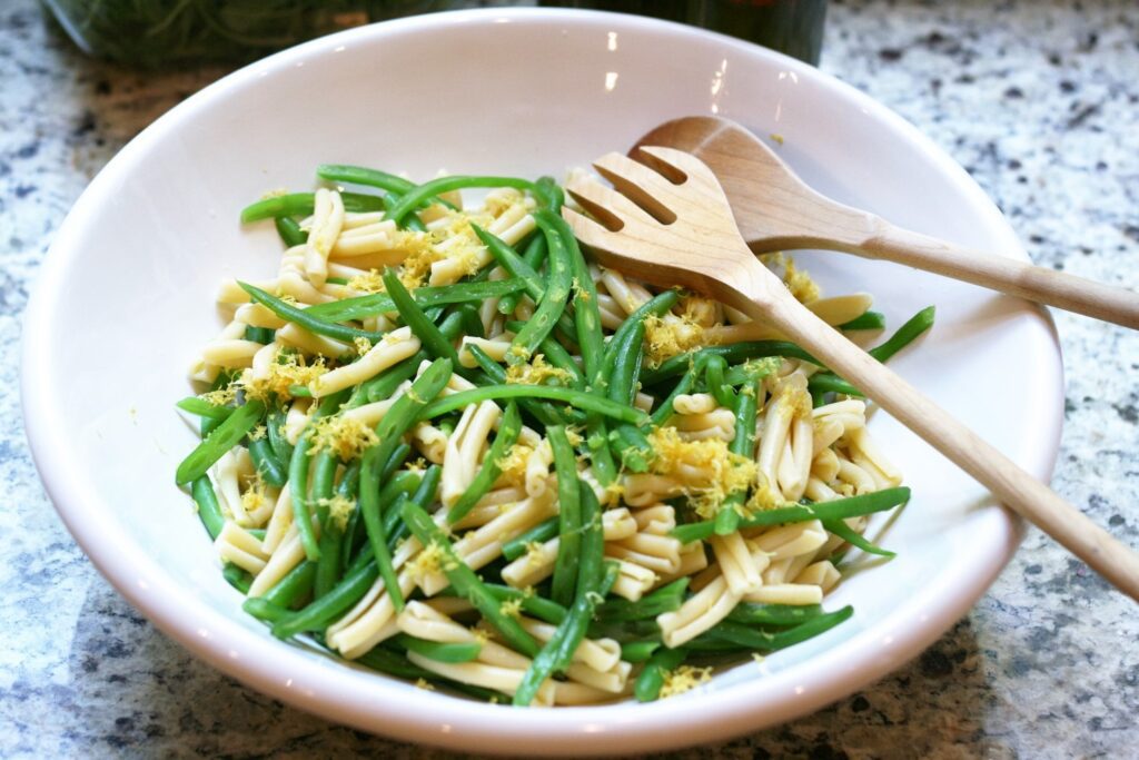 Add pasta beans and lemon zest to bowl