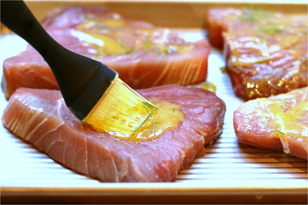 Brush Lemon Garlic Rosemary Glaze on Tuna Steaks