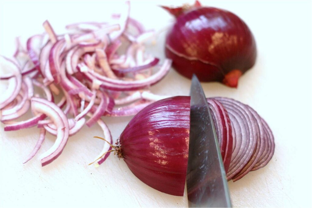 Chop red onions into half rings