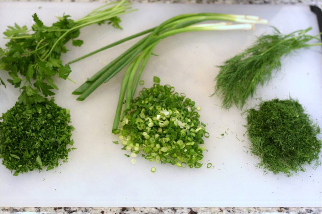 Chop the parsley, scallions and dill for herbed salmon