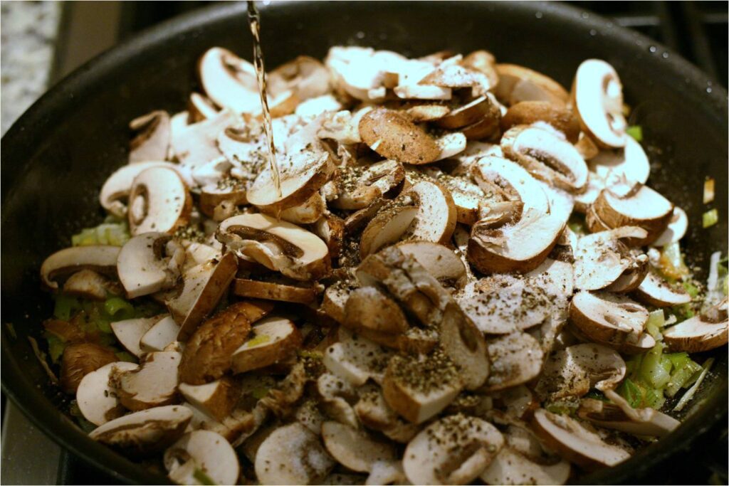 Cook down chopped cremini mushrooms with leeks