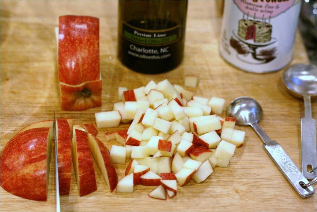 Dice apples for Low-fat Oatmeal Cookies