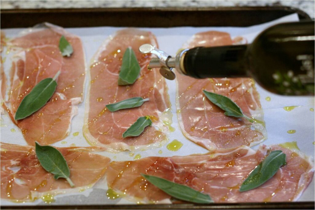 Drizzle EVOO over prosciutto and sage