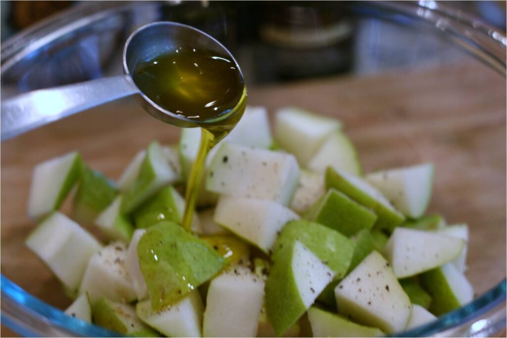 EVOO on pears for Pineapple Pear Gorganzola Salad