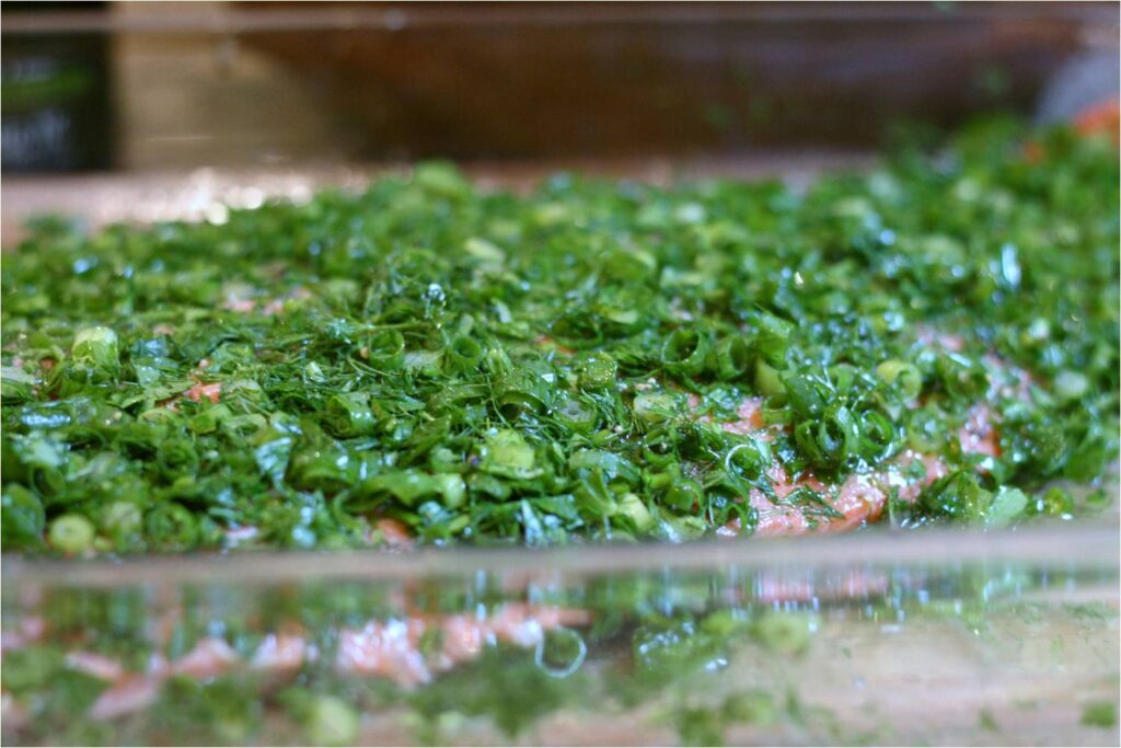 Generously coat both sides with green herbs