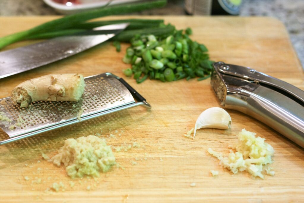 Mince garlic and grate ginger and chop scallions