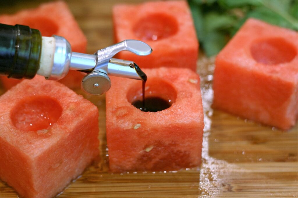 Pour balsamic in melon cube