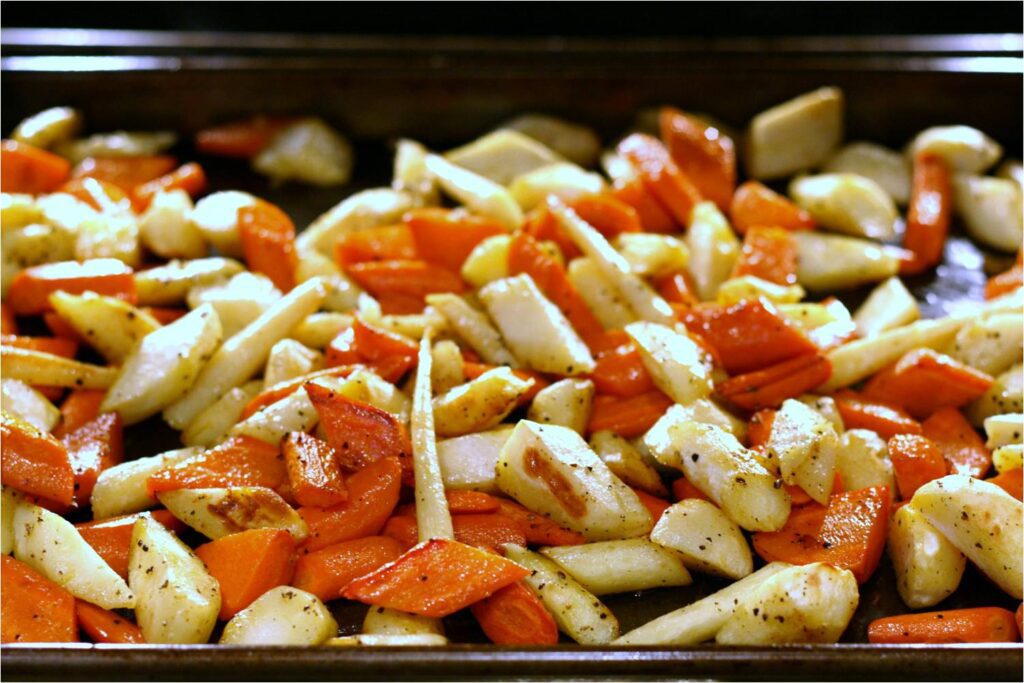 Roast carrots and parsnips on baking pan