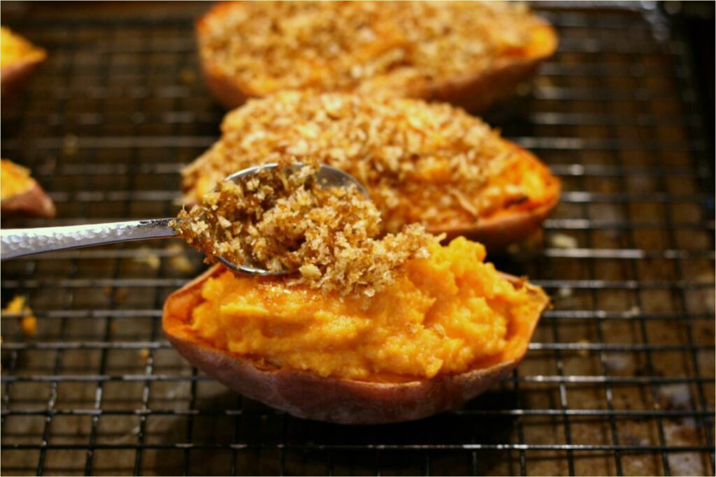 Spoon Topping Onto Sweet Potatoes