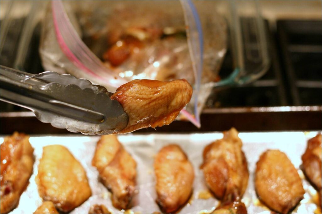 Transfer balsamic rosemary chicken wings from bag to baking sheet