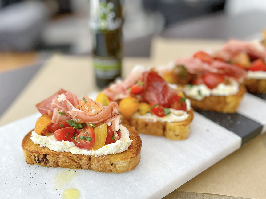 Herbs de Provence, heirloom tomato, orange and Italian ham bruschetta